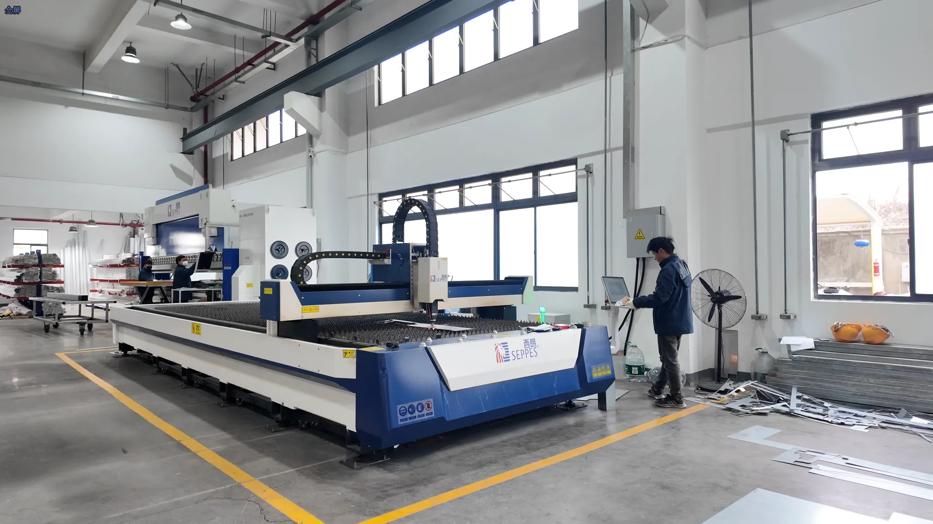 SEPPES factory workshop with metal processing equipment and an operator at a control station