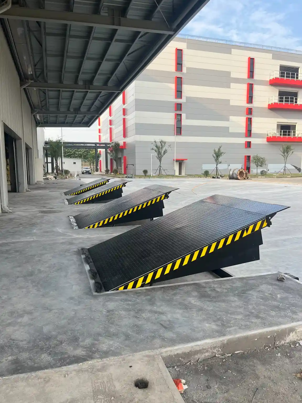 Black dock leveler with a raised lip at a loading bay